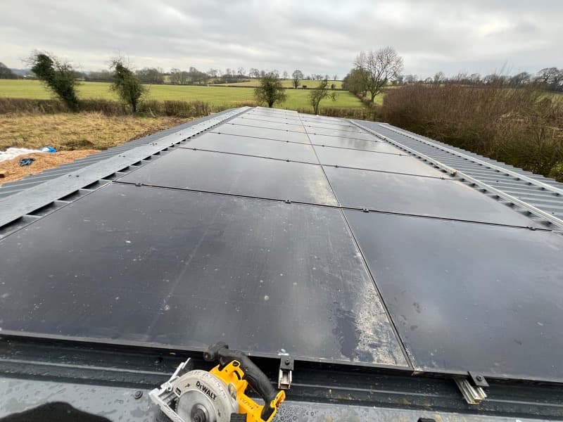 Solar panels installed on corrugated metal barn roof by Lunar Solar, Essex